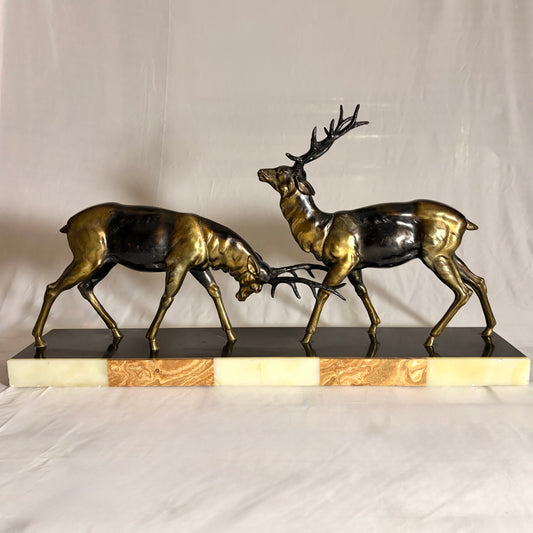 AN ART DECO PATINATED METAL GROUP OF TWO RUTTING STAGS, FRANCE, c. 1900–1930