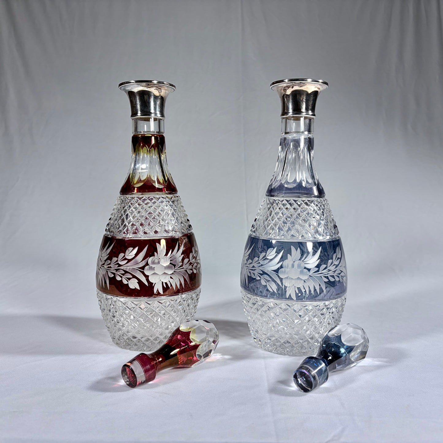 PAIR OF ELIZABETH II CUT-TO-CLEAR SILVER-MOUNTED GLASS DECANTERS, LONDON, 1971