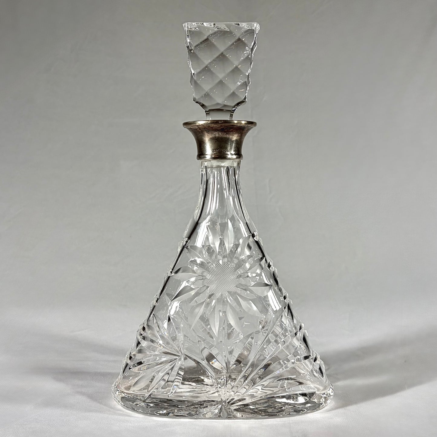 TRIANGULAR CUT-GLASS AND STERLING SILVER-MOUNTED DECANTER, LONDON, 1968