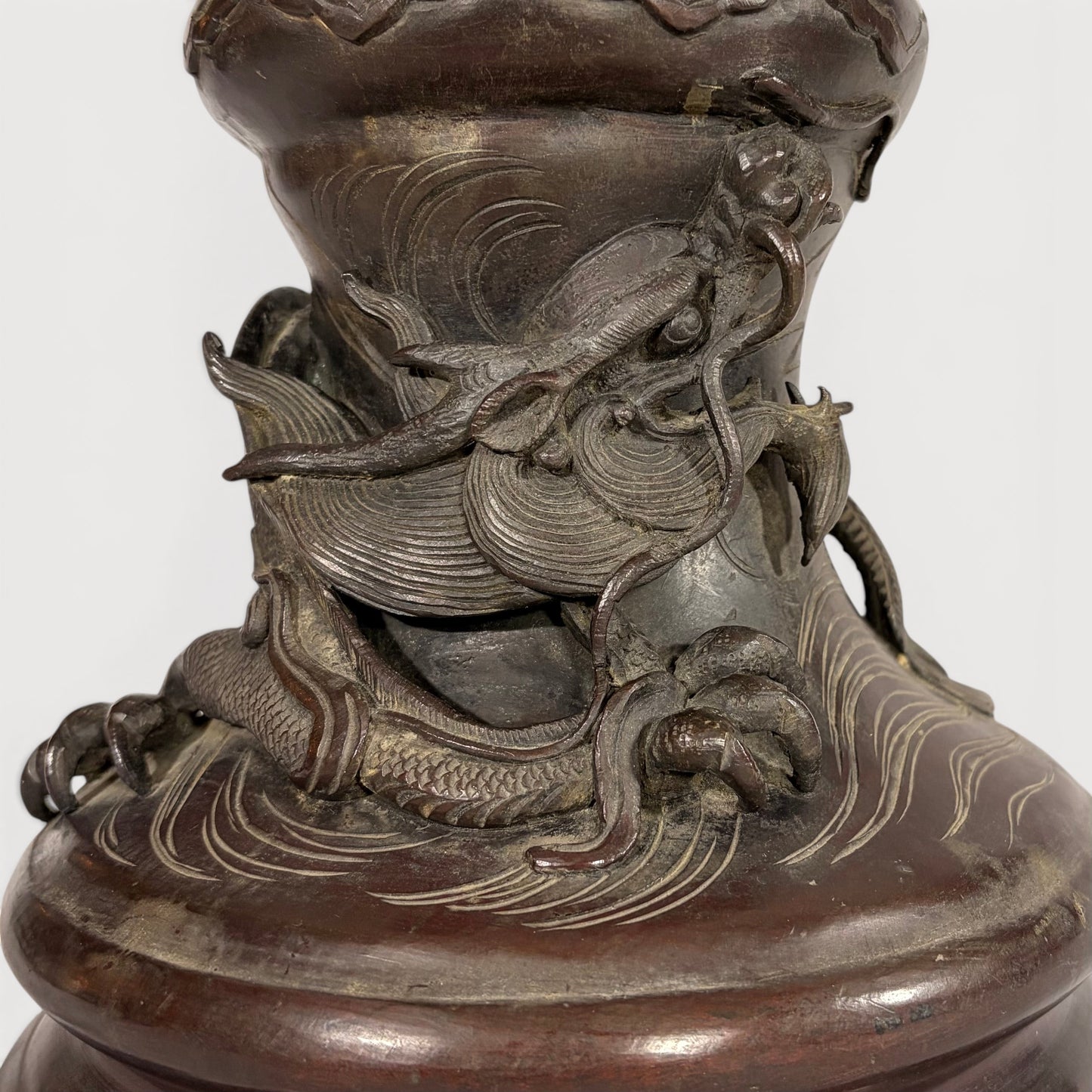 KLS Vaults patinated bronze baluster vase with a sculpted dragon and waves, late Meiji period Japanese metalwork.