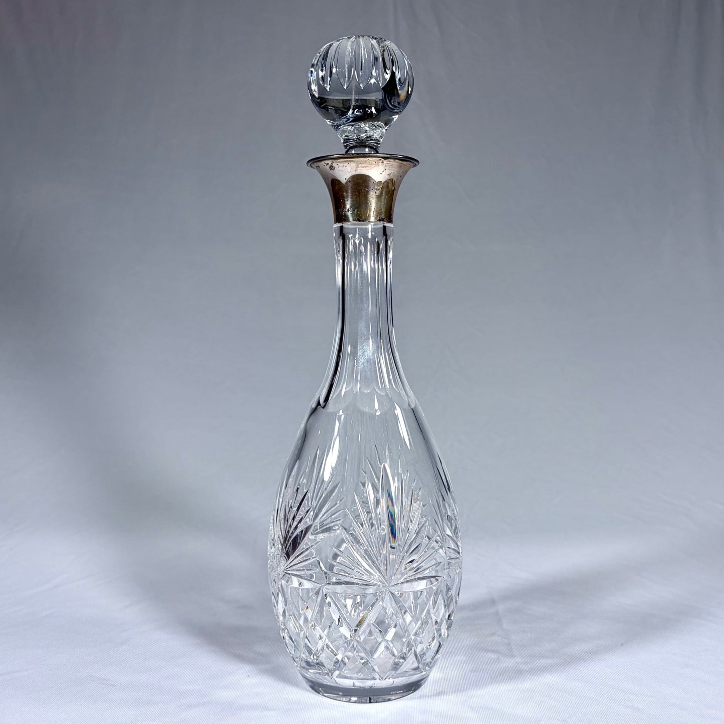 KLS Vaults large cut crystal decanter with sterling silver neck and fluted ball stopper, Birmingham 1990.