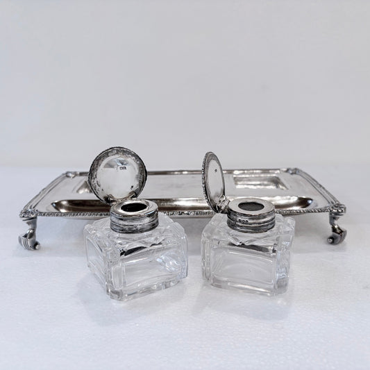 KLS Vaults Edwardian sterling silver inkstand with gadrooned border, claw-and-ball feet, and two glass inkwells.