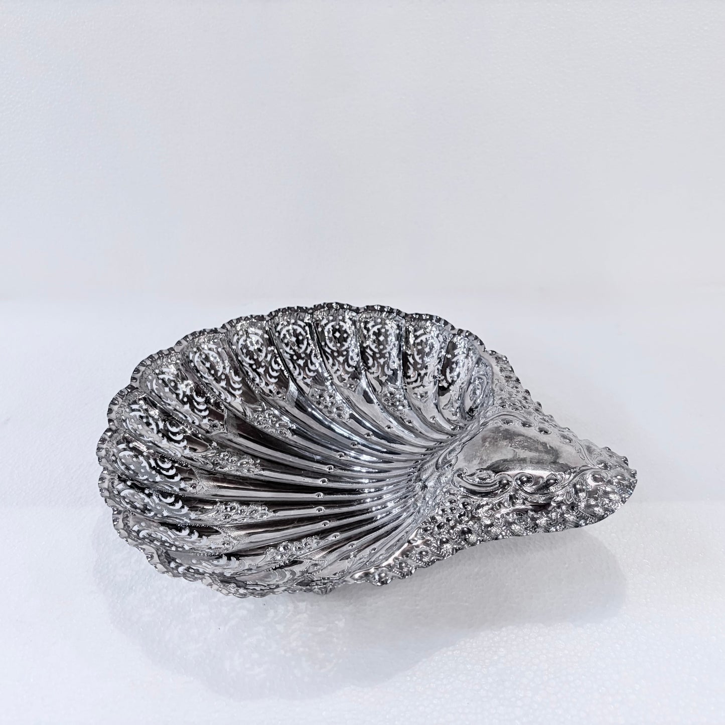 KLS Vaults Edwardian sterling silver shell-form centerpiece with intricate pierced panels and rococo scroll handle.