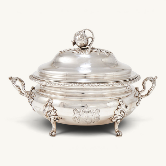 KLS Vaults George III silver oval soup tureen with gadrooned rim, scrolled handles, and pomegranate finial.