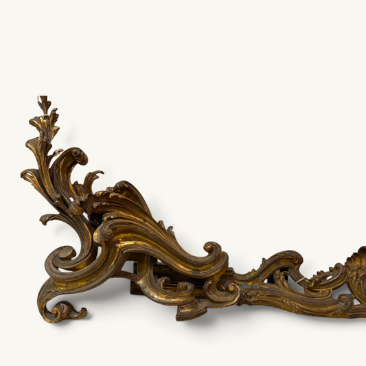 KLS Vaults Louis XV style gilded bronze fireplace fender with intricate rococo acanthus leaf and scroll detailing.