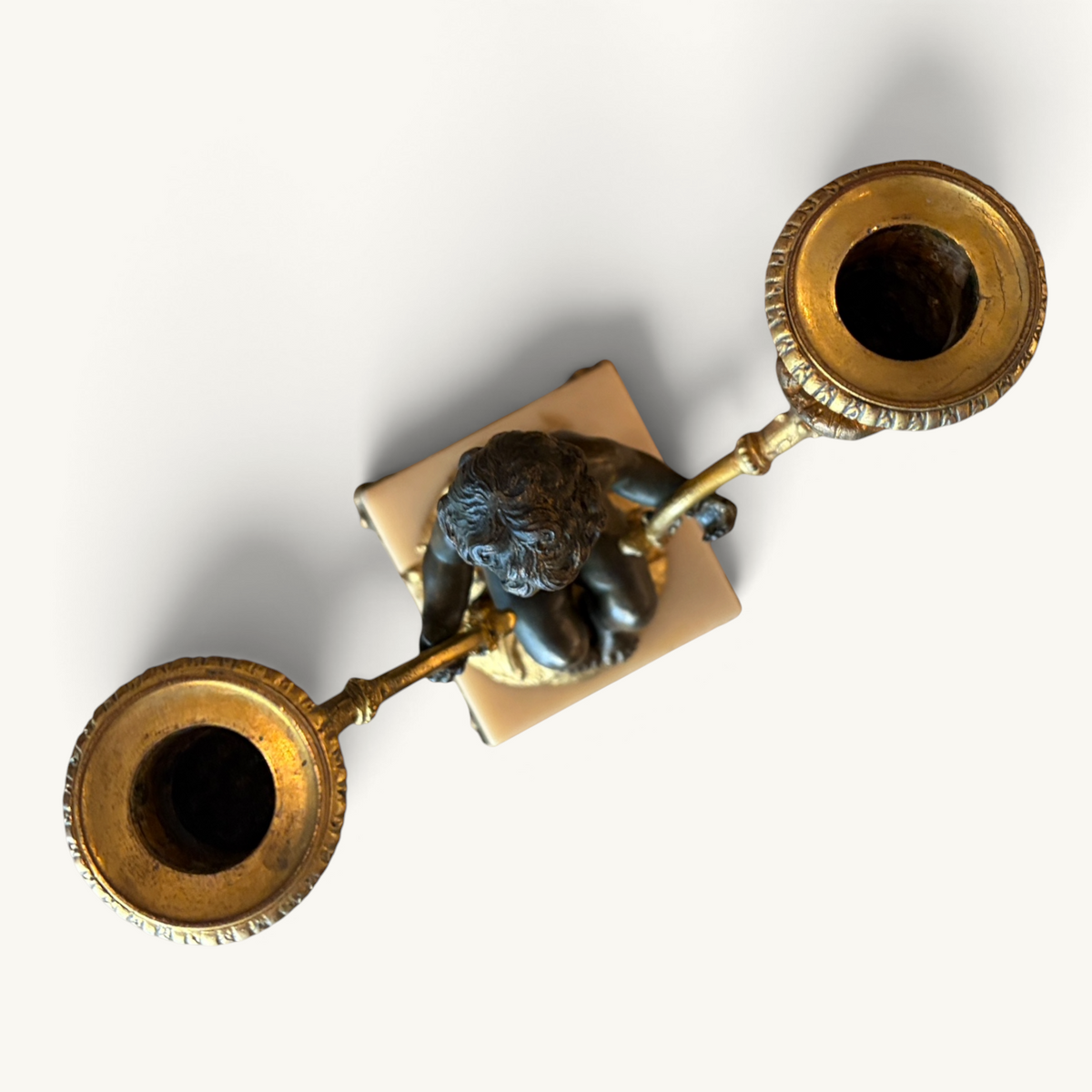 KLS Vaults Napoleon III twin-light candelabra with patinated bronze putti, ormolu branches, and marble plinth base.
