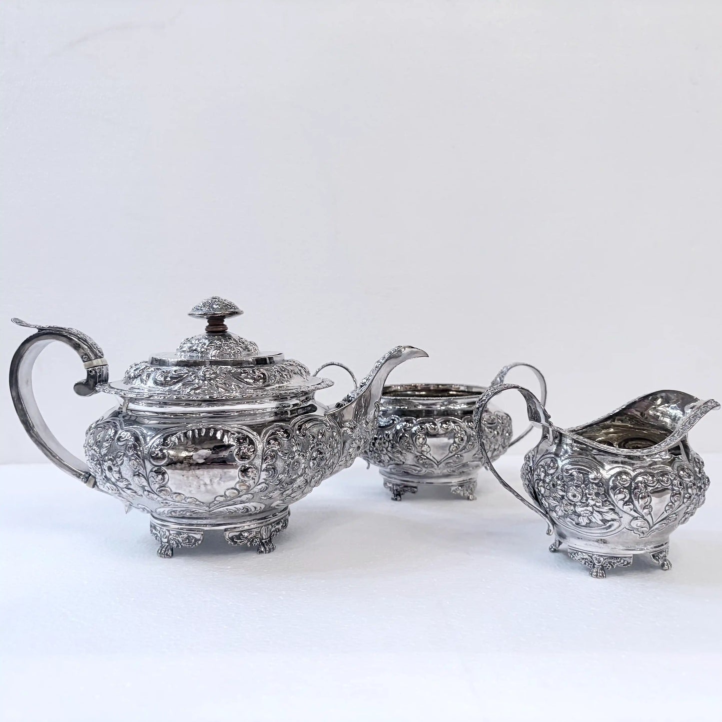 GEORGIAN CHASED SILVER THREE-PIECE TEA SERVICE, LONDON, 1822