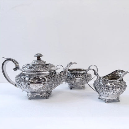 GEORGIAN CHASED SILVER THREE-PIECE TEA SERVICE, LONDON, 1822