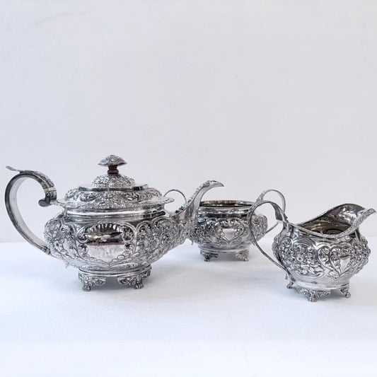 GEORGIAN CHASED SILVER THREE-PIECE TEA SERVICE, LONDON, 1822