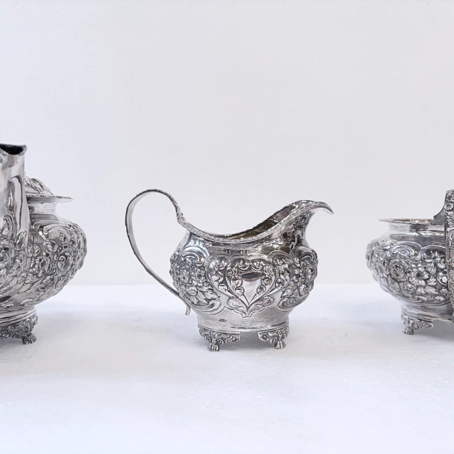GEORGIAN CHASED SILVER THREE-PIECE TEA SERVICE, LONDON, 1822