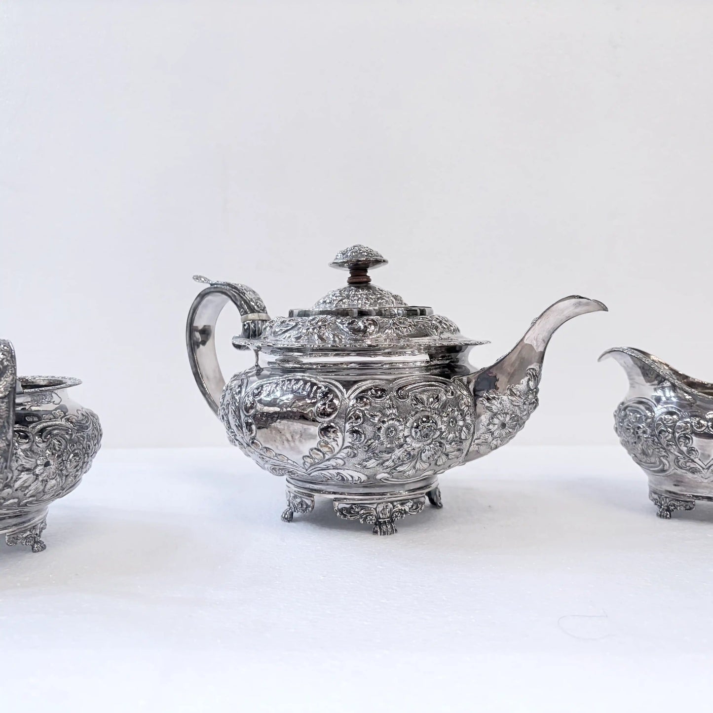 GEORGIAN CHASED SILVER THREE-PIECE TEA SERVICE, LONDON, 1822