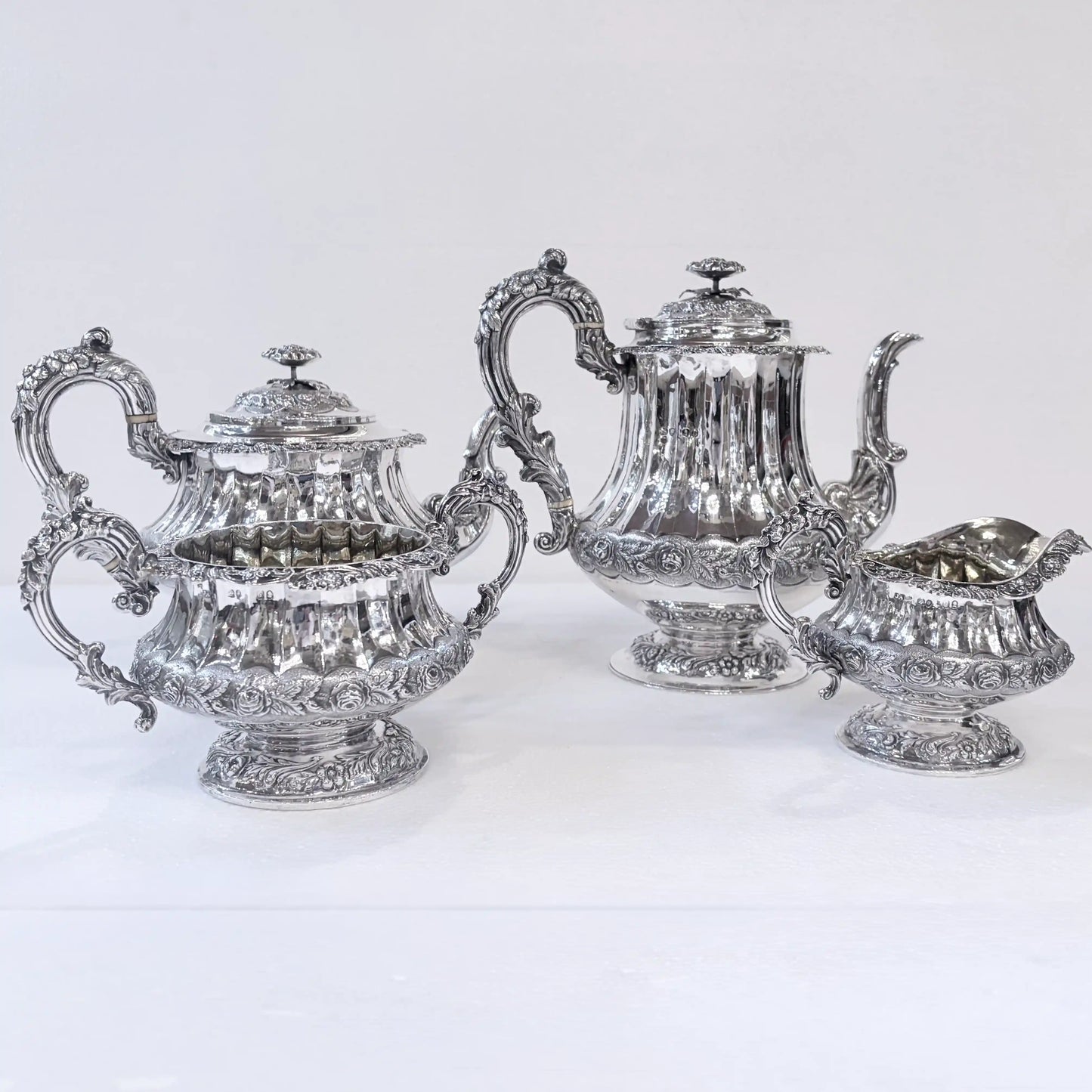 GEORGIAN CHASED AND REPOUSSÉ FOUR PIECE SILVER TEA SERVICE, LONDON, 1824