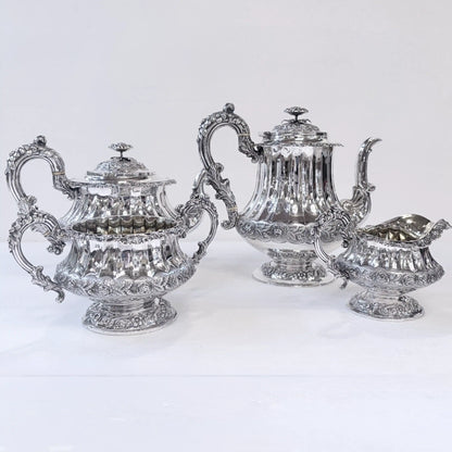 GEORGIAN CHASED AND REPOUSSÉ FOUR PIECE SILVER TEA SERVICE, LONDON, 1824