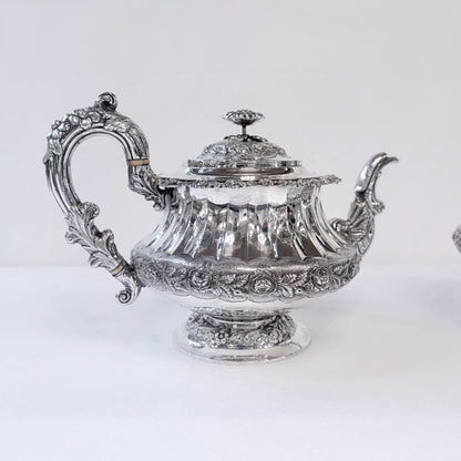 GEORGIAN CHASED AND REPOUSSÉ FOUR PIECE SILVER TEA SERVICE, LONDON, 1824