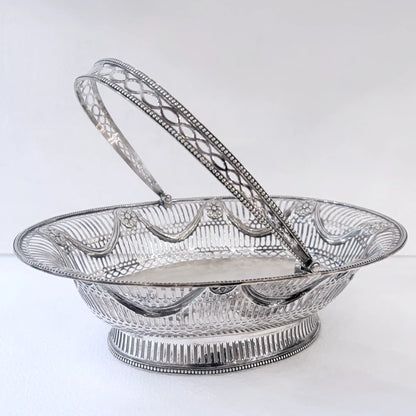 EDWARDIAN PIERCED STERLING SILVER SWING-HANDLED BASKET, LONDON, 1912