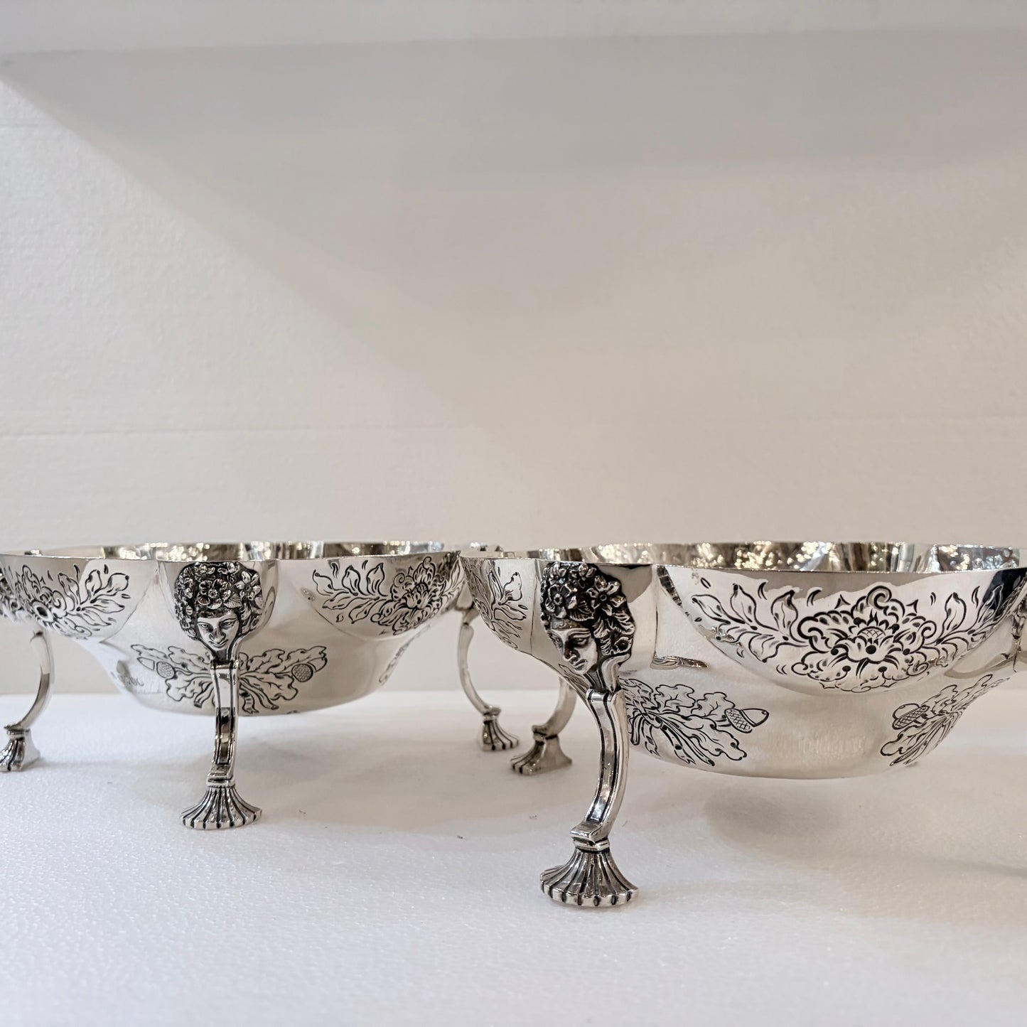 A PAIR OF LATE VICTORIAN REPOUSSÉ STERLING SILVER CENTERPIECES, LONDON, 1889