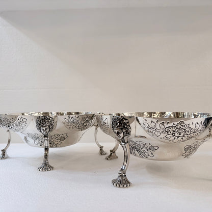 A PAIR OF LATE VICTORIAN REPOUSSÉ STERLING SILVER CENTERPIECES, LONDON, 1889