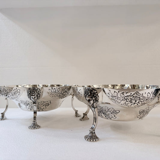 A PAIR OF LATE VICTORIAN REPOUSSÉ STERLING SILVER CENTERPIECES, LONDON, 1889