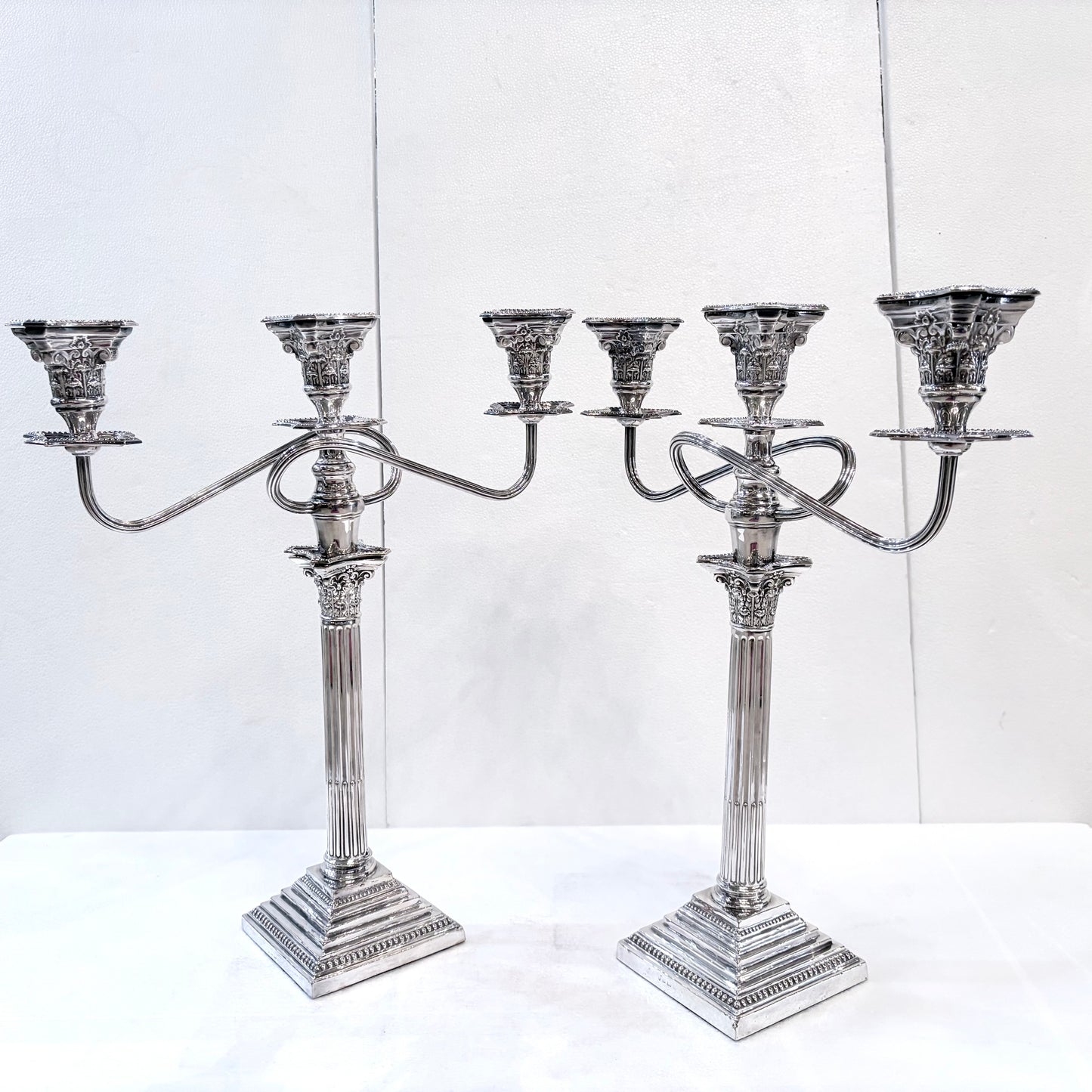 A PAIR OF GEORGE III STYLE CORINTHIAN COLUMN THREE-LIGHT CANDLESTICKS, ENGLISH, 1890