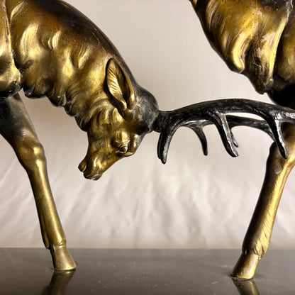 AN ART DECO PATINATED METAL GROUP OF TWO RUTTING STAGS, FRANCE, c. 1900–1930