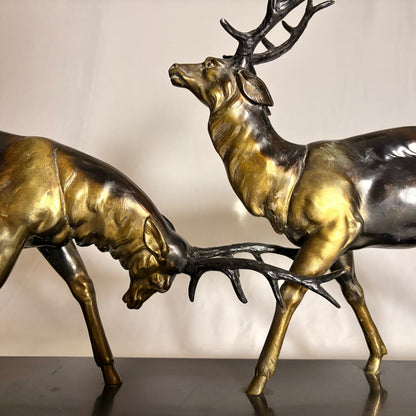 AN ART DECO PATINATED METAL GROUP OF TWO RUTTING STAGS, FRANCE, c. 1900–1930