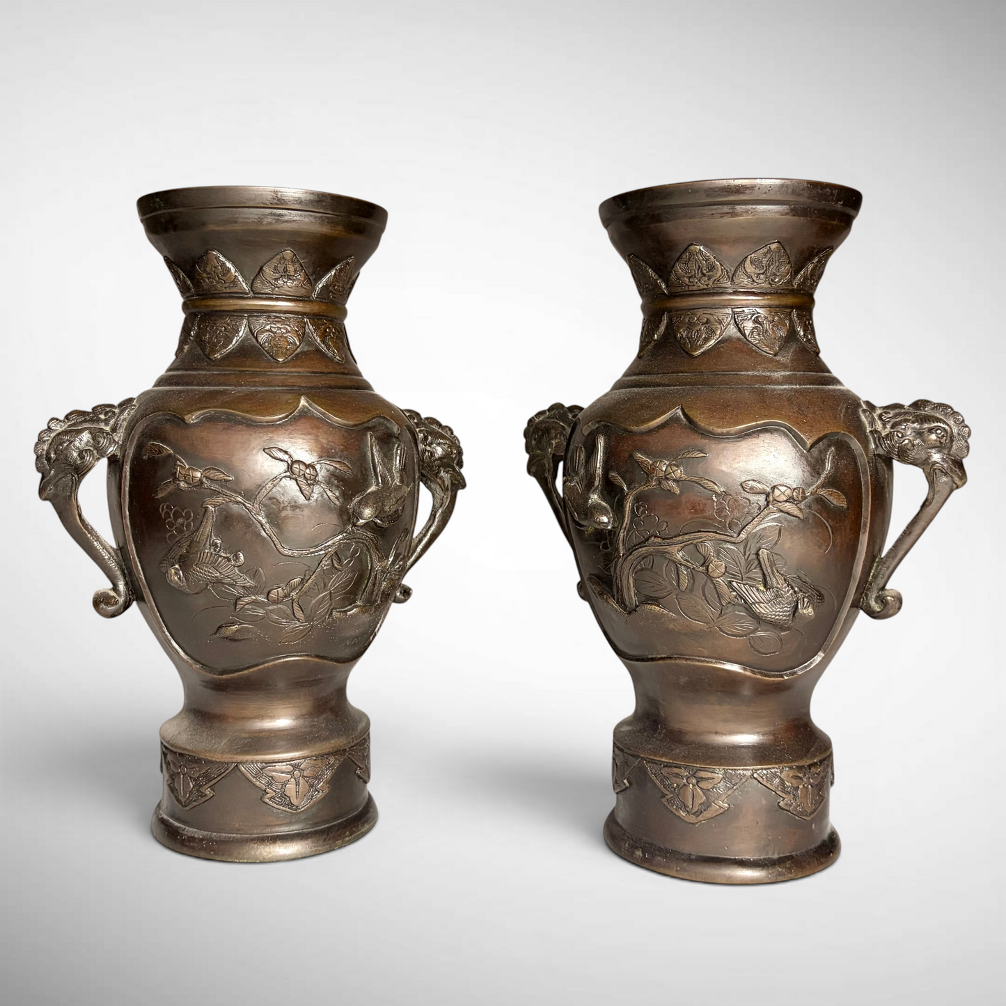 PAIR OF MEIJI PERIOD RELIEF-CAST BRONZE VASES, JAPAN, C.1870–1900