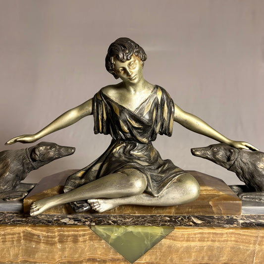 AN ART DECO FIGURAL GROUP OF A SEATED LADY WITH TWO HOUNDS, FRANCE, C.1920s