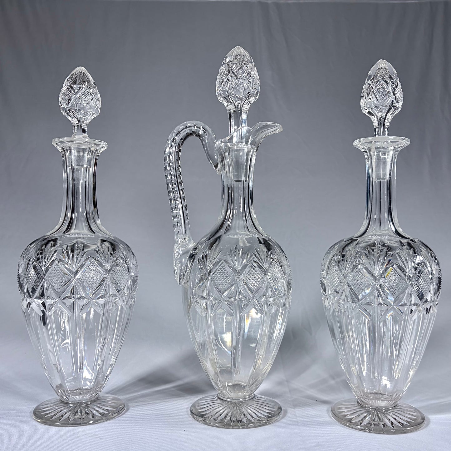 A TRIPLE-SUITE OF CUT-GLASS DECANTERS AND CLARET JUG, WEST EUROPE, 19th CENTURY
