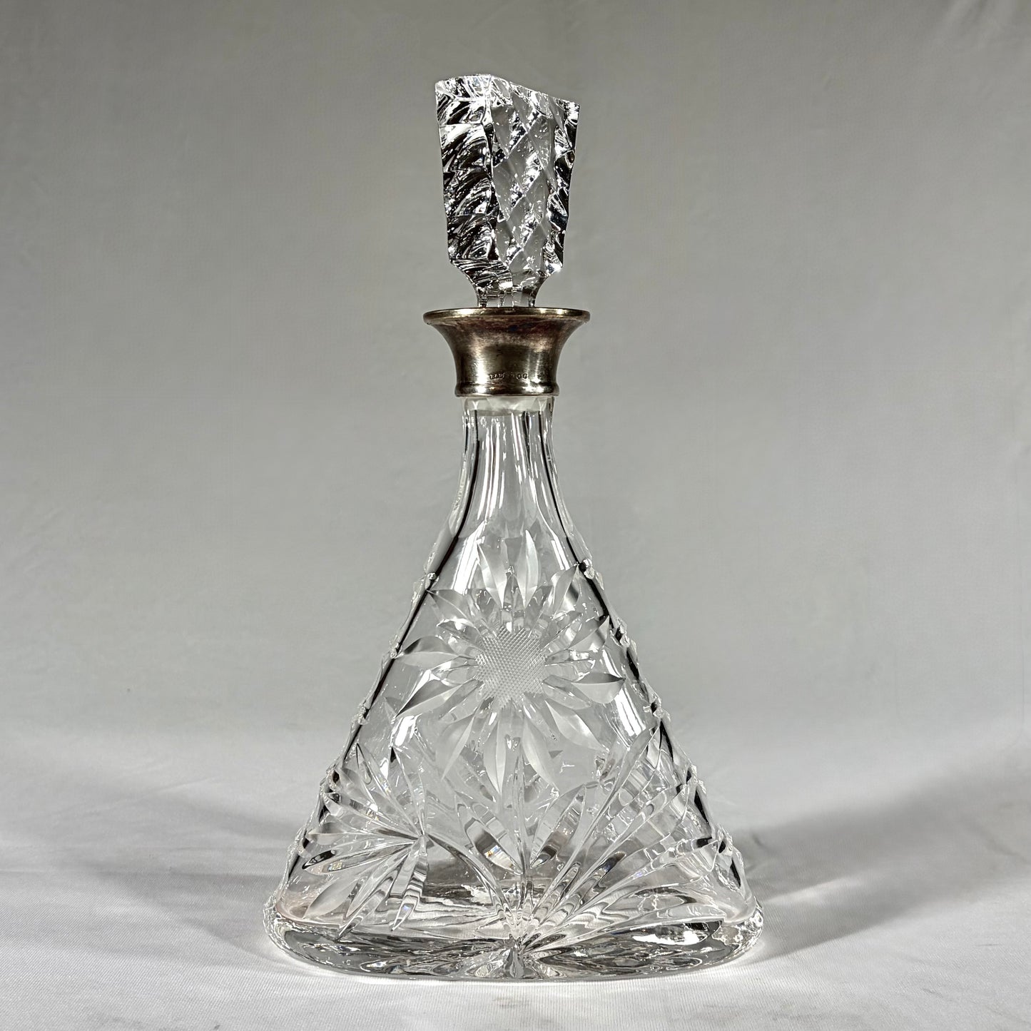 TRIANGULAR CUT-GLASS AND STERLING SILVER-MOUNTED DECANTER, LONDON, 1968