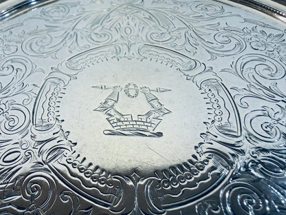 A SMALL VICTORIAN CHASED STERLING SILVER SALVER, LONDON, 1876