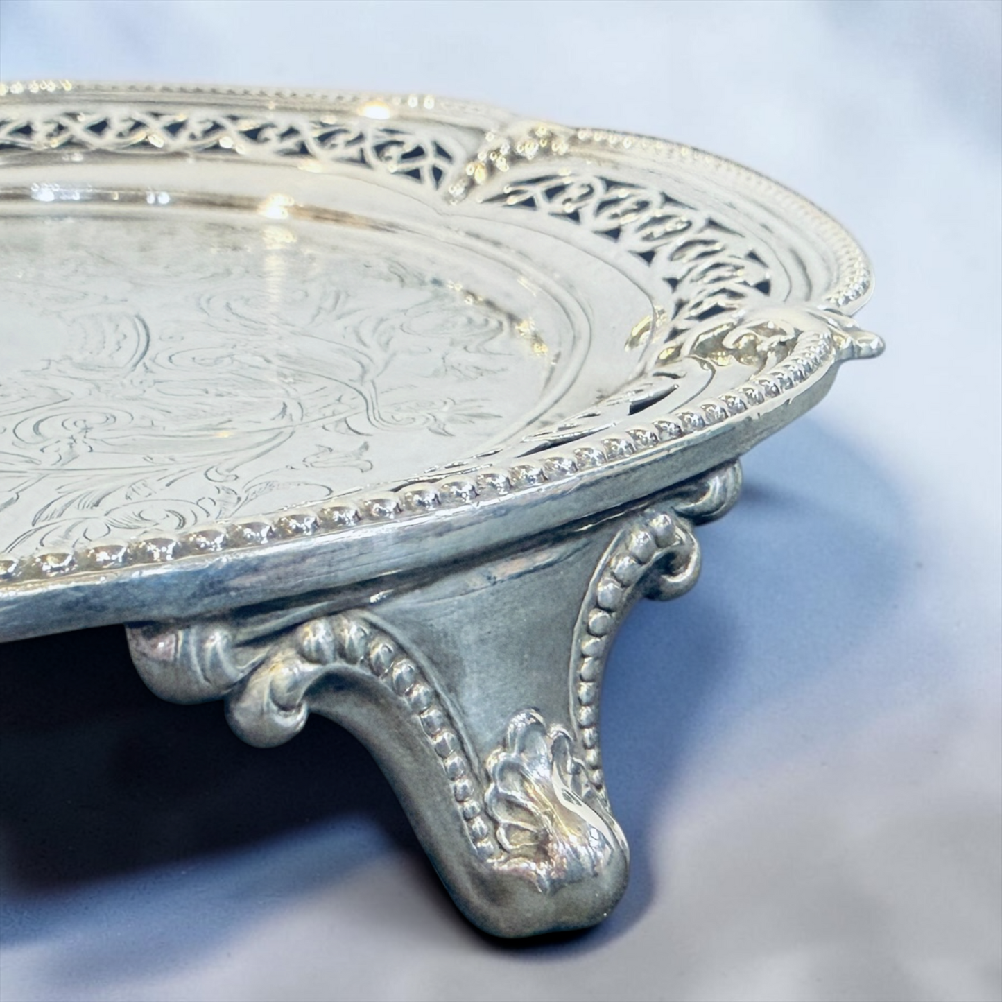 A SMALL VICTORIAN CHASED STERLING SILVER SALVER, LONDON, 1876