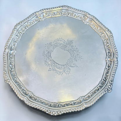 AN ENGRAVED AND GADROONED STERLING SILVER SALVER, LONDON, 1910