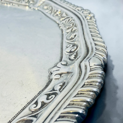 AN ENGRAVED AND GADROONED STERLING SILVER SALVER, LONDON, 1910