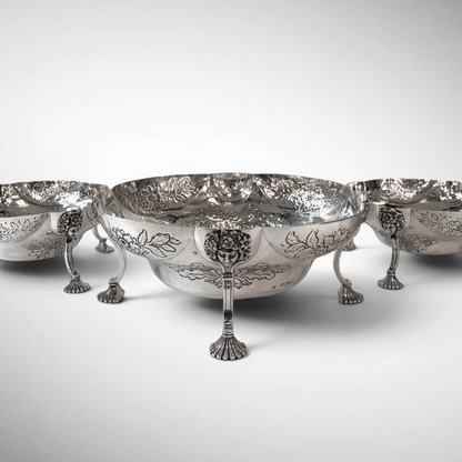 A SET OF THREE LATE VICTORIAN REPOUSSÉ STERLING SILVER CENTERPIECES, LONDON, 1889