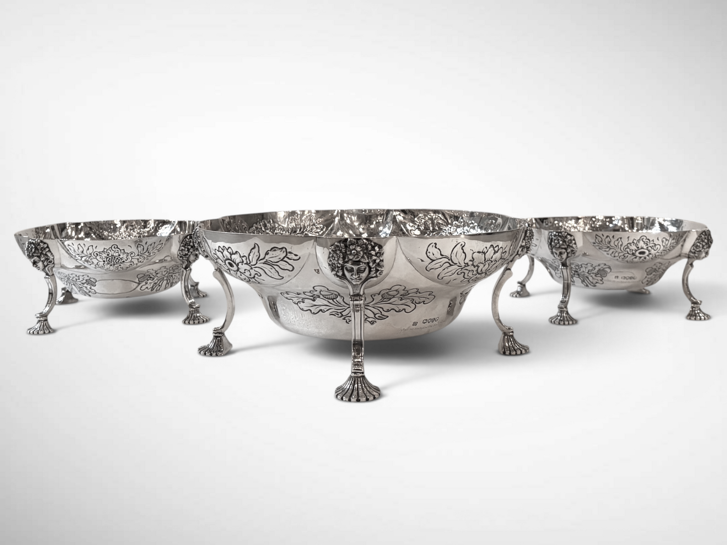 A SET OF THREE LATE VICTORIAN REPOUSSÉ STERLING SILVER CENTERPIECES, LONDON, 1889