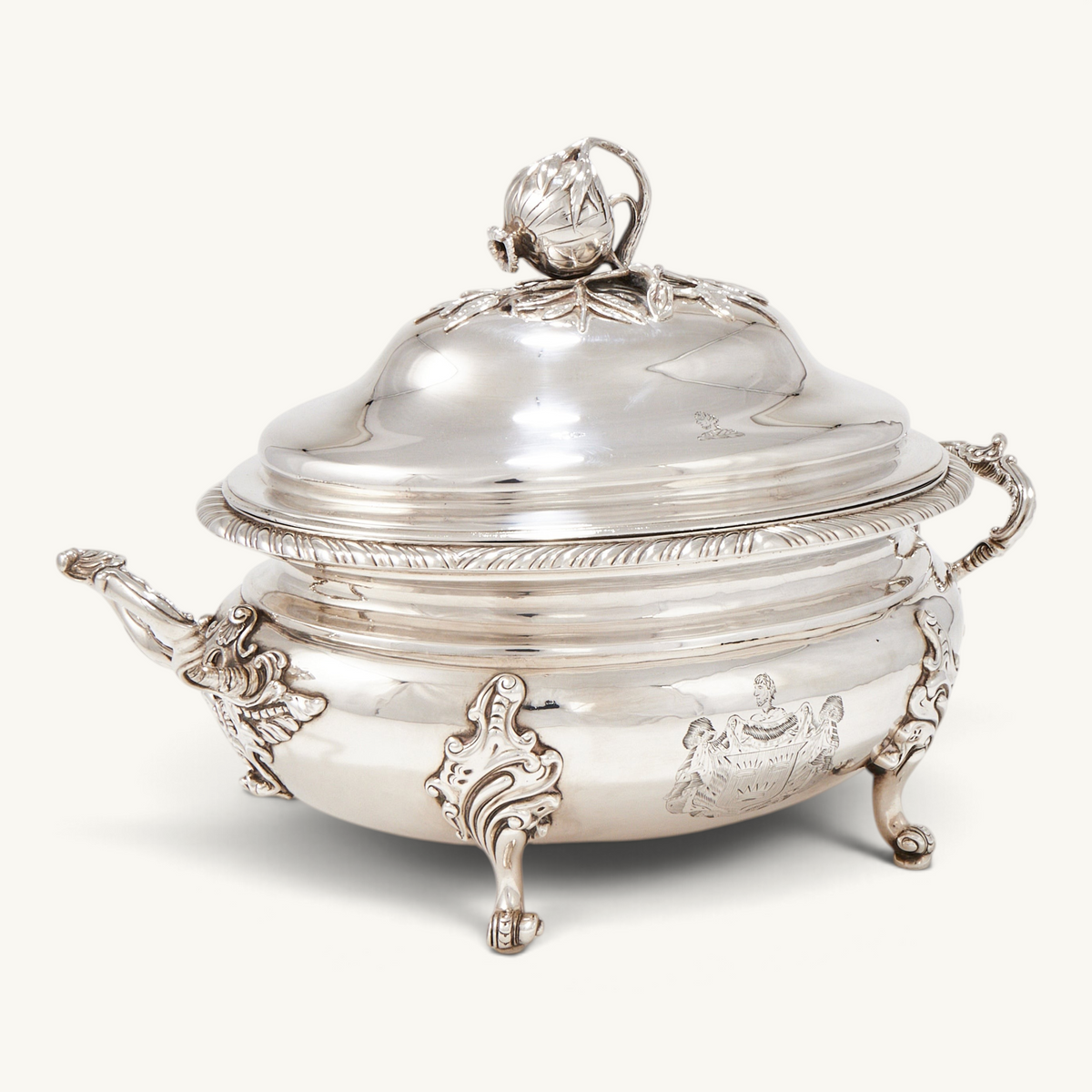 KLS Vaults George III silver oval soup tureen with gadrooned rim, scrolled feet, and pomegranate finial cover.