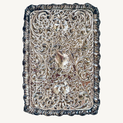 KLS Vaults 1927 George V sterling silver dressing tray with intricate repoussé floral, scroll, and Green Man mask motifs.