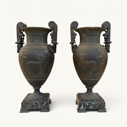 KLS Vaults pair of 19th-century French ovoid urns with dark Pompeian patina, swan-neck handles, and marble plinths.