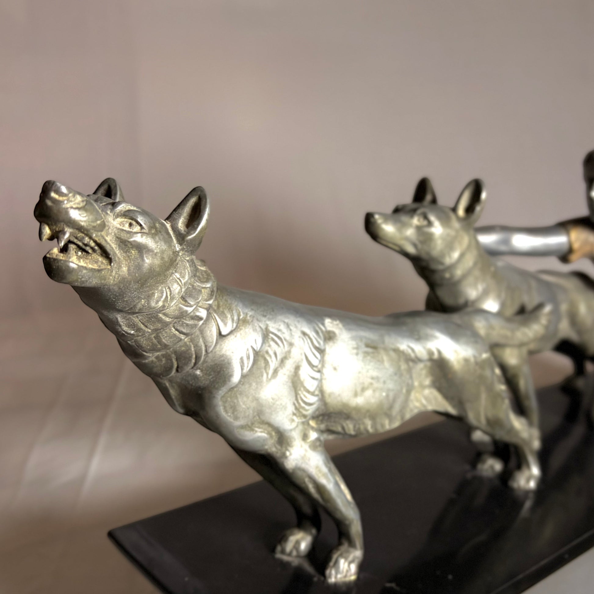KLS Vaults Art Deco silvered spelter sculpture of a maiden restraining two wolves on a black marble base