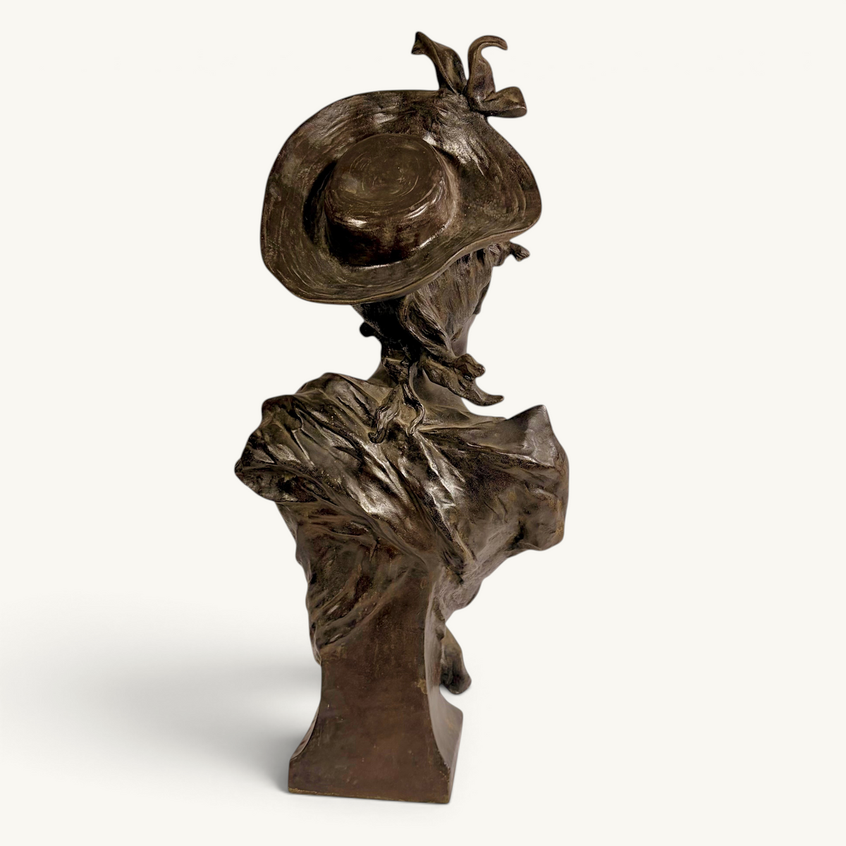 KLS Vaults Art Nouveau patinated bronze bust of a young woman wearing a wide-brimmed hat and flowing bodice, France, late 19th century.
