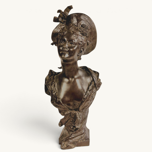 KLS Vaults patinated bronze bust of a young woman in an elaborate hat, Art Nouveau style, late 19th century.