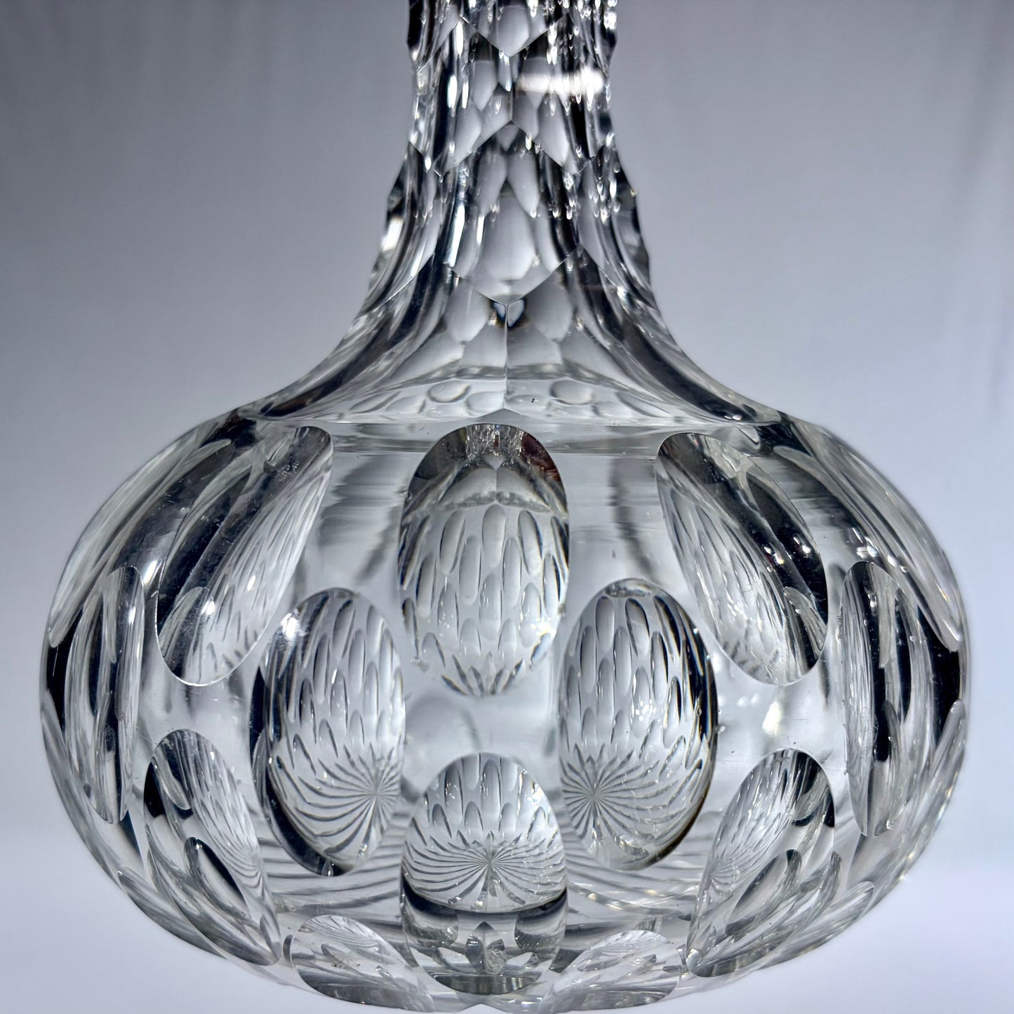KLS Vaults mid-century Bohemian lead crystal spirit decanter with deep-cut oval thumbprint patterns and faceted neck.