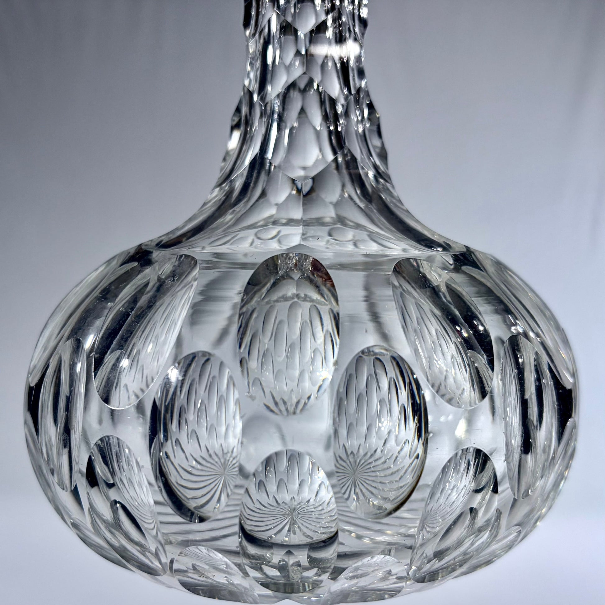 KLS Vaults mid-century Bohemian lead crystal spirit decanter with deep-cut oval thumbprint patterns and faceted neck.