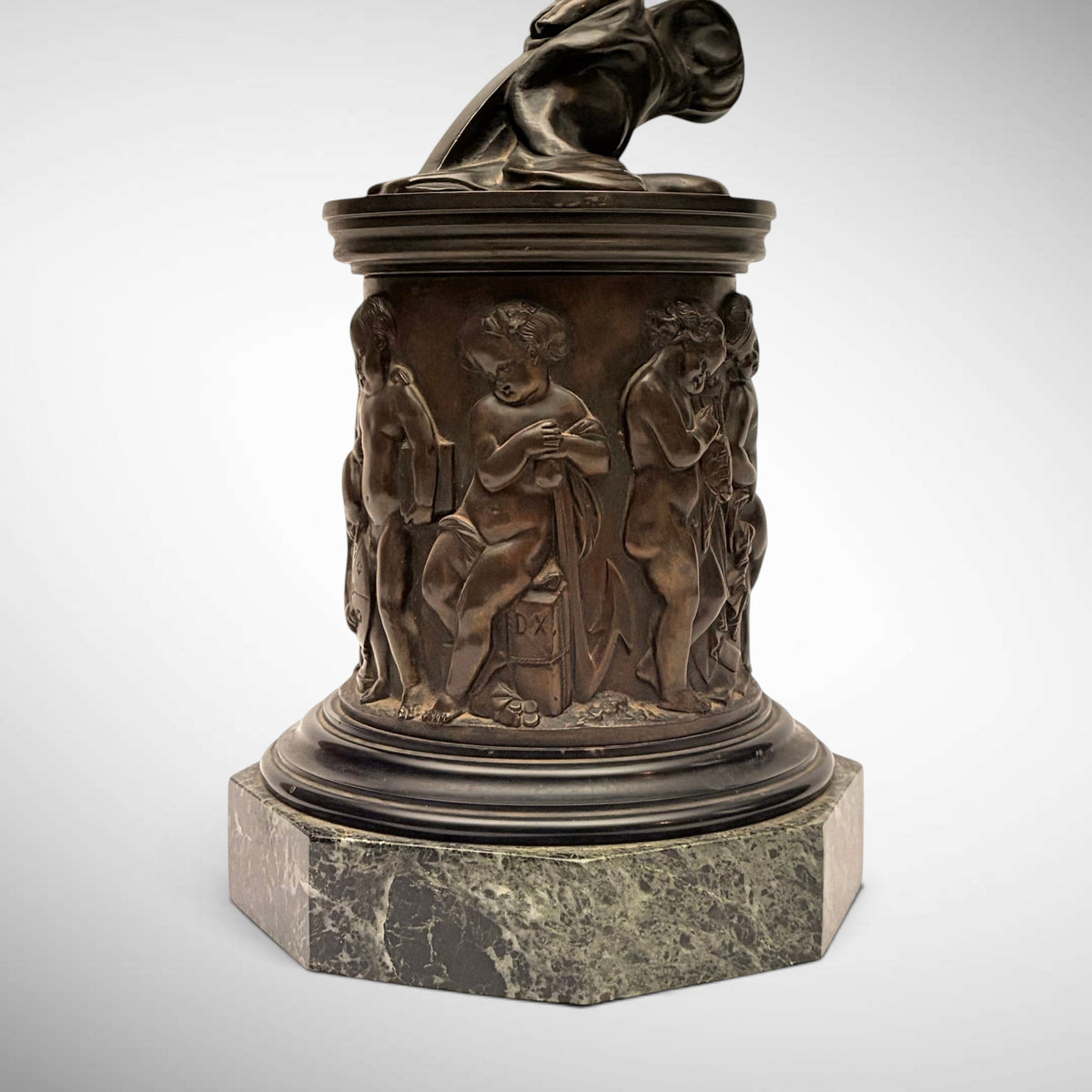 KLS Vaults neoclassical patinated bronze Atropos figure pedestal with relief-cast putti on a green marble plinth