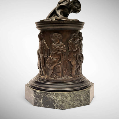 KLS Vaults neoclassical patinated bronze Atropos figure pedestal with relief-cast putti on a green marble plinth