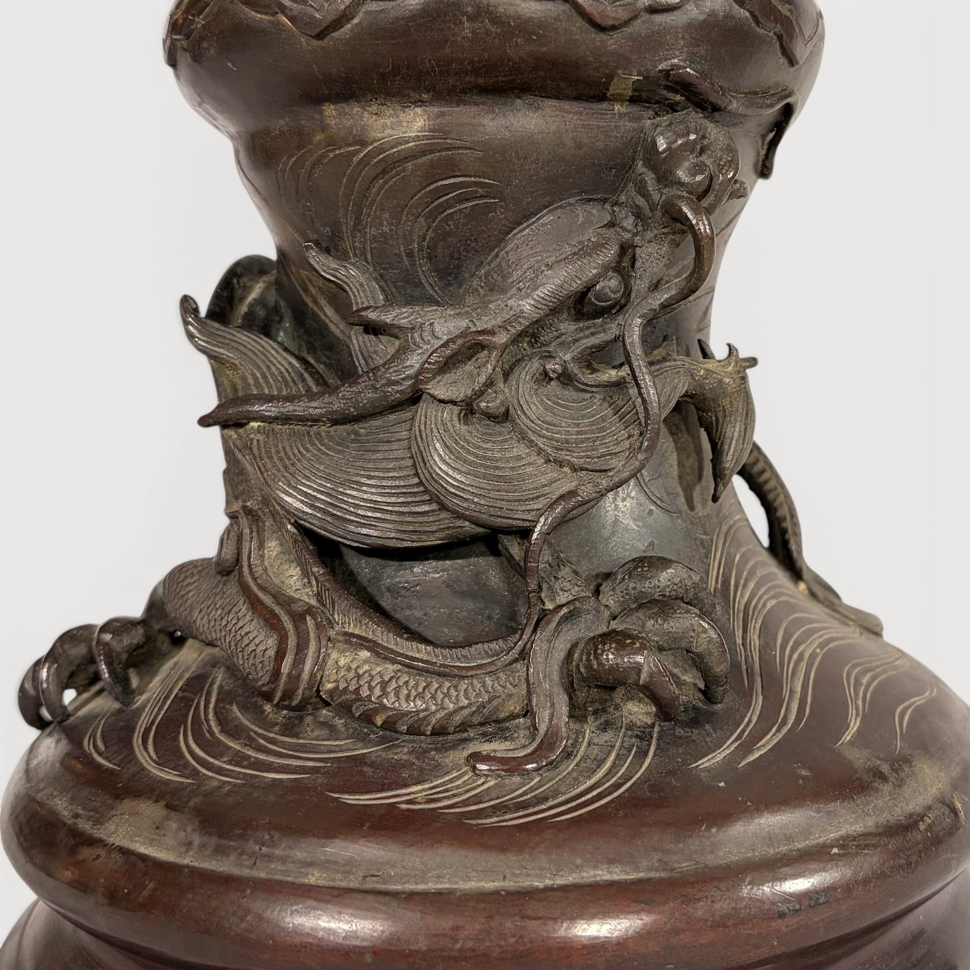 KLS Vaults patinated bronze baluster vase with a sculpted dragon and waves, late Meiji period Japanese metalwork.