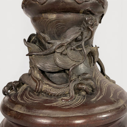 KLS Vaults patinated bronze baluster vase with a sculpted dragon and waves, late Meiji period Japanese metalwork.