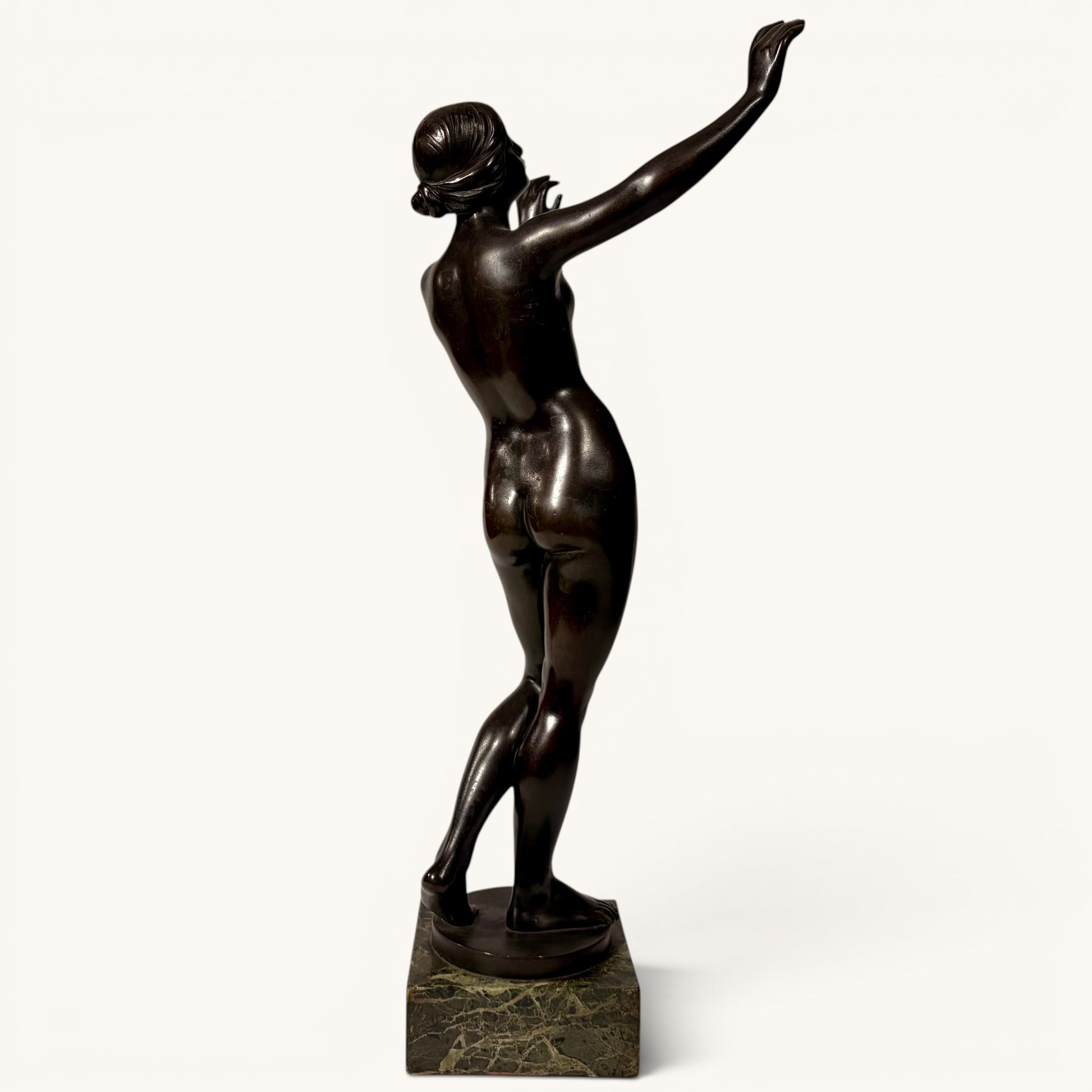 KLS Vaults patinated bronze sculpture of a nude female figure in a dynamic pose, Art Nouveau style, on a marble base.