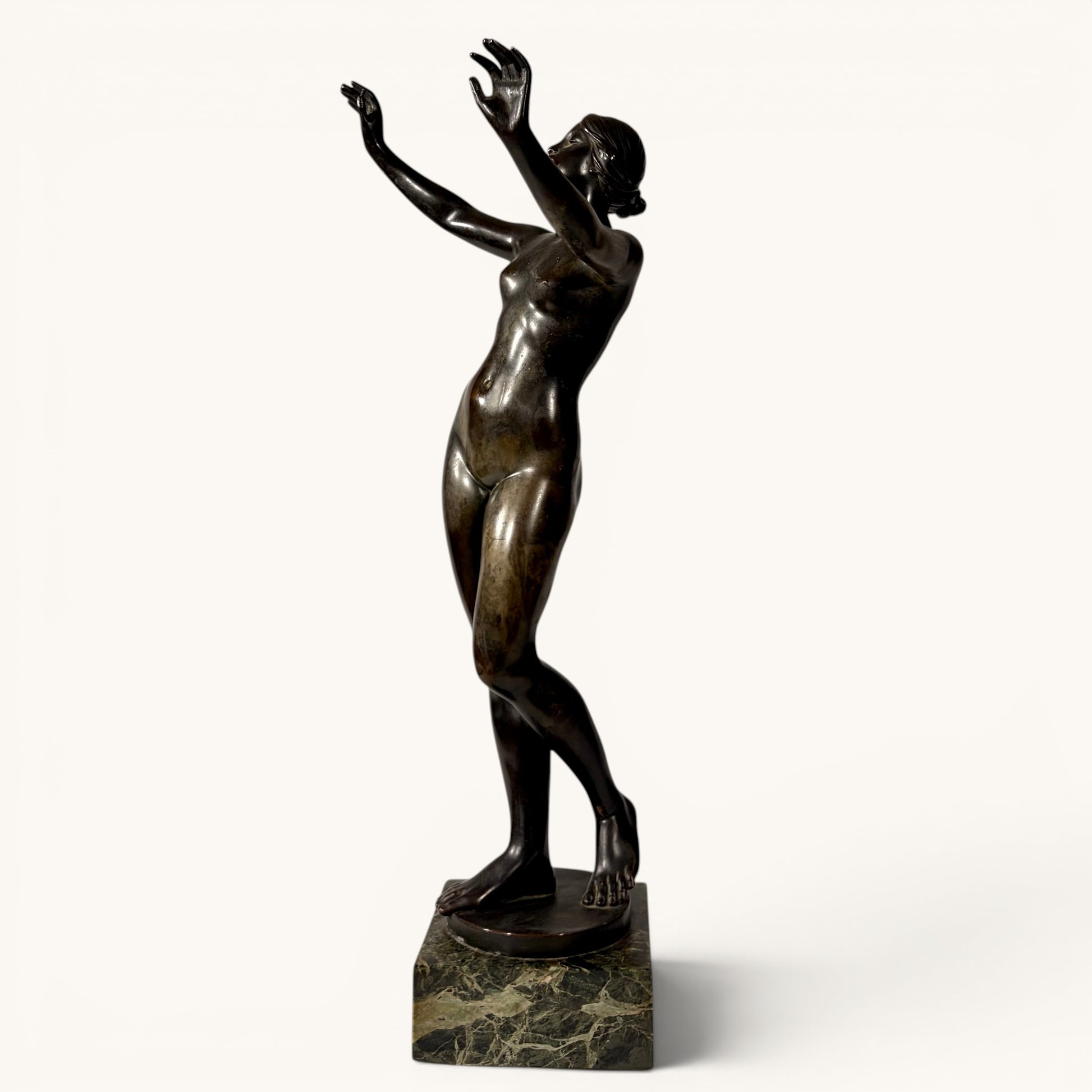 KLS Vaults patinated bronze sculpture of a nude female figure in a dynamic pose on a marble base, Art Nouveau style.