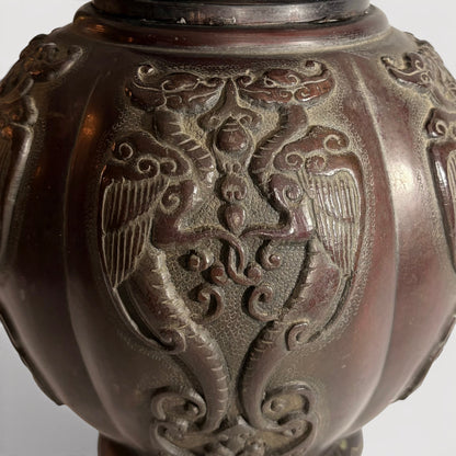 KLS Vaults Japanese Meiji period bronze vase featuring detailed relief carvings of phoenix panels in chocolate patina.